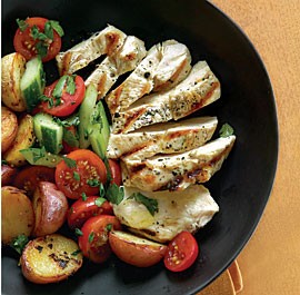 Grilled chicken and potatoes with tomato and cucumber salad