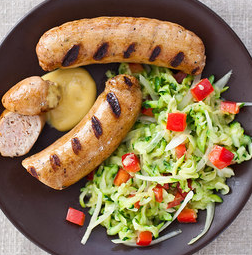 Grilled chicken sausage with mustard sauce and zucchini slaw