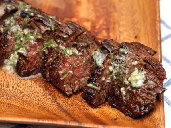 Grilled chipotle-rubbed steaks with lime butter