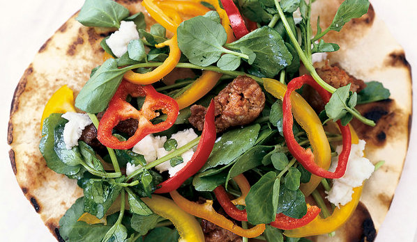 Grilled chorizo, goat cheese, and watercress pita pizzas
