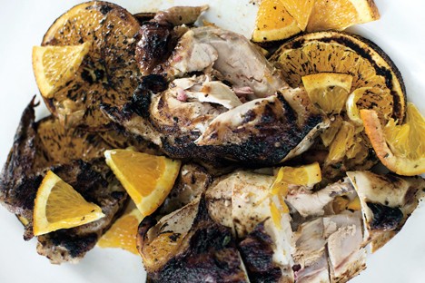 Grilled citrus chicken under a brick