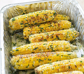 Grilled corn with flavored butter