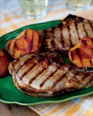 Grilled country pork chops with bourbon-basted grilled peaches