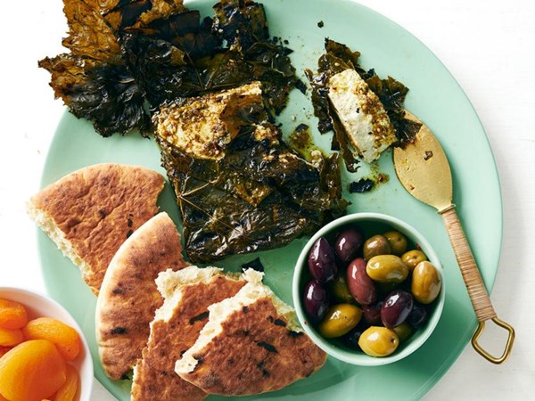Grilled feta wrapped in grape leaves