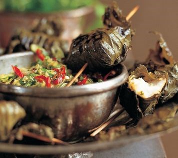 Grilled fish in vine leaves with green zchug