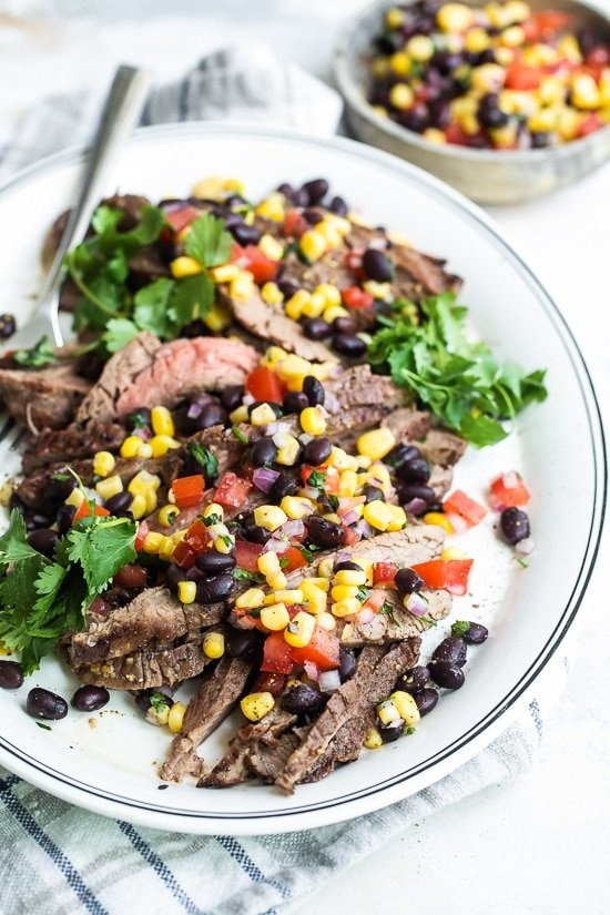 Grilled flank steak with black beans corn and tomatoes