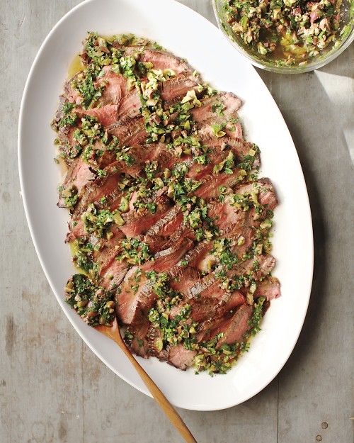 Grilled flank steak with olive and herb sauce