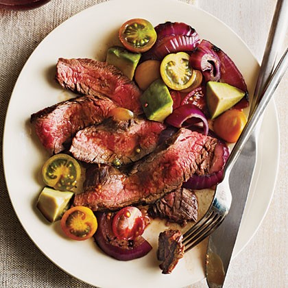 Grilled flank steak with onions, avocado, and tomatoes