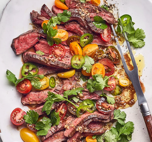 Grilled flank steak with tomato salad