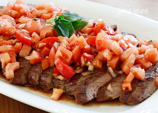 Grilled flank steak with tomatoes, red onion and balsamic