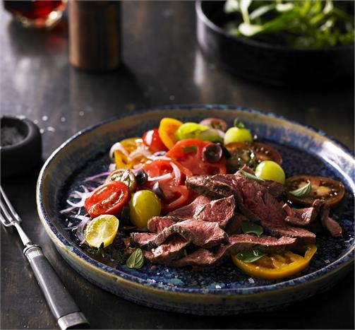 Grilled flat iron steak with tomato, olive and oregano salad