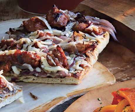 Grilled flatbreads with caramelized onions, sausage, and Manchego cheese