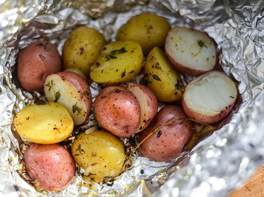 Grilled foil-wrapped potatoes with shallots, lemon, and thyme