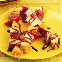 Grilled fruit skewers with chocolate syrup