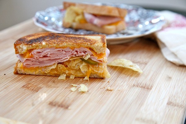Grilled ham, cheese, pickle, and potato chip sandwich