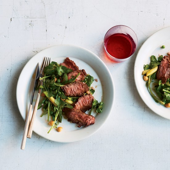 Grilled hanger steak with spring vegetables and hazelnuts
