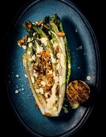 Grilled hearts of romaine with chilli pumpkin seeds