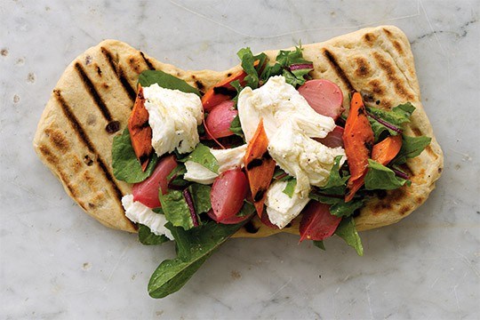 Grilled herb and onion flatbread with mozzarella, grilled carrots, braised radish, and dandelion salad