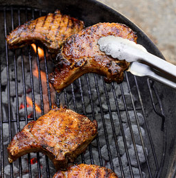 Grilled honey-glazed pork chops with peach, red onion, and arugula salad