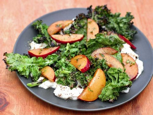 Grilled kale salad with ricotta and plums