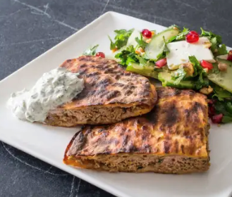 Grilled lamb-stuffed pitas with yogurt sauce