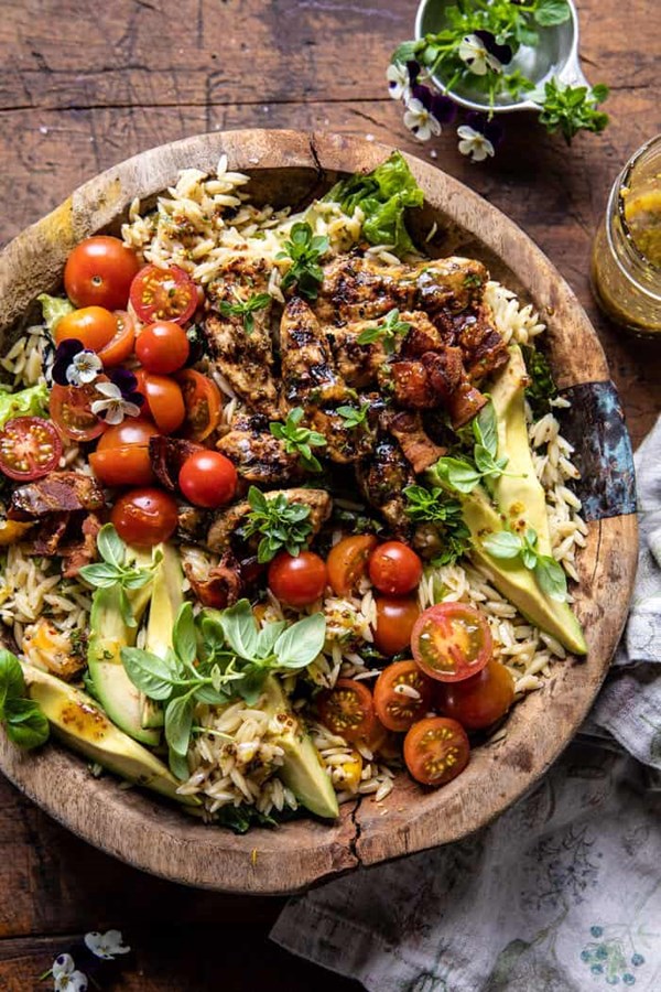 Grilled lemon herb chicken avocado orzo salad with honey mustard bacon dressing