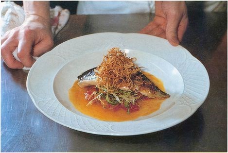 Grilled mackerel with stewed tomatoes, pesto and onions