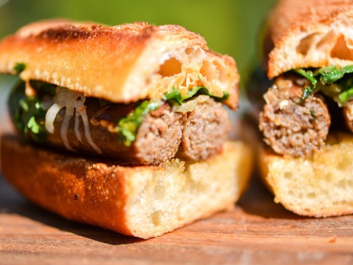 Grilled merguez sandwiches with caramelized onions, Manchego, and harissa mayonnaise
