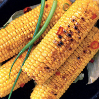 Grilled mielies with garlicky herb butter
