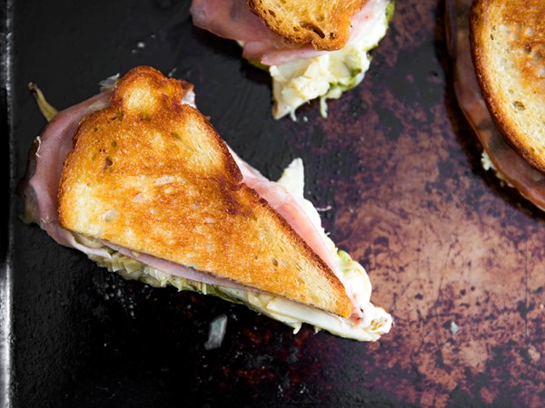 Grilled mozzarella sandwiches with mortadella, pesto, and artichokes