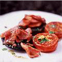Grilled mushrooms with crispy bacon bits and tomatoes