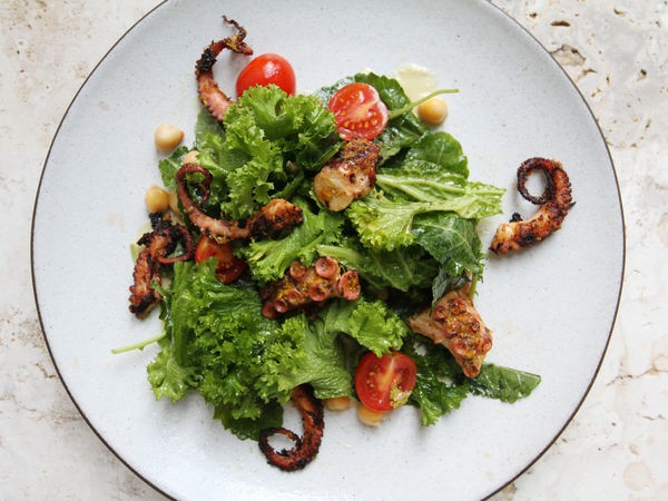 Grilled octopus with chickpeas, cherry tomatoes, and anchovy vinaigrette