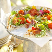 Grilled onion flatbread with bacon and arugula
