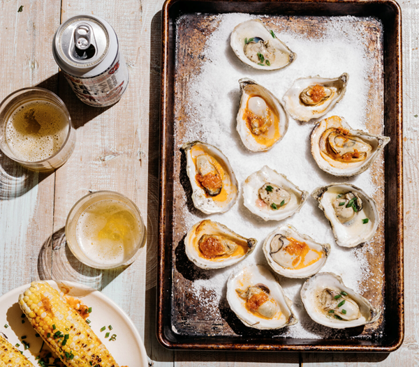 Grilled oysters with tomato-horseradish and mignonette butters and corn on the cob