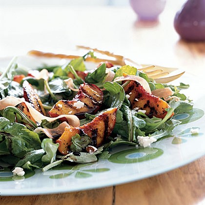 Grilled peaches over arugula with goat cheese and prosciutto