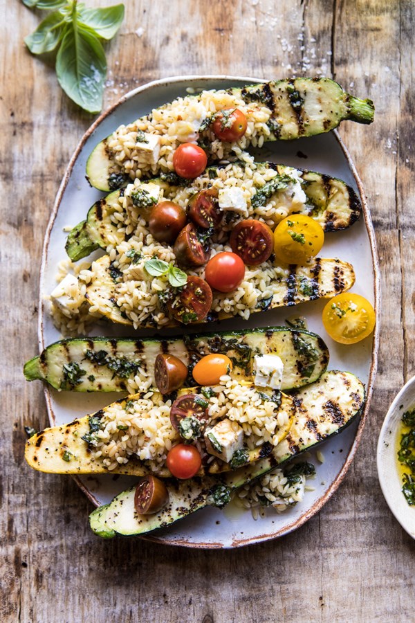 Grilled pesto zucchini stuffed with tomatoes and orzo