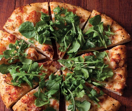 Grilled pizza with mozzarella, arugula, and chile oil