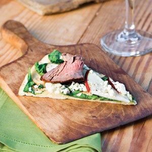 Grilled pizza with steak, pear, and arugula