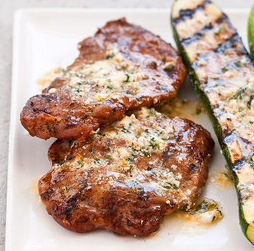 Grilled pork cutlets and zucchini with feta and mint compound butter