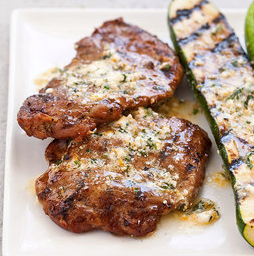 Grilled pork cutlets and zucchini with feta and mint compound butter