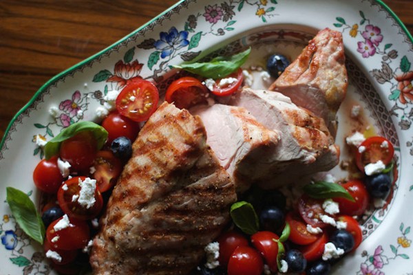 Grilled pork tenderloin with goat cheese, tomato, and blueberry salad