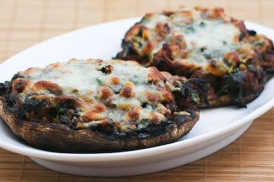 Grilled portobello mushrooms stuffed with sausage, spinach, and cheese