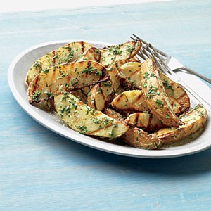 Grilled potato wedges with fresh herbs and butter