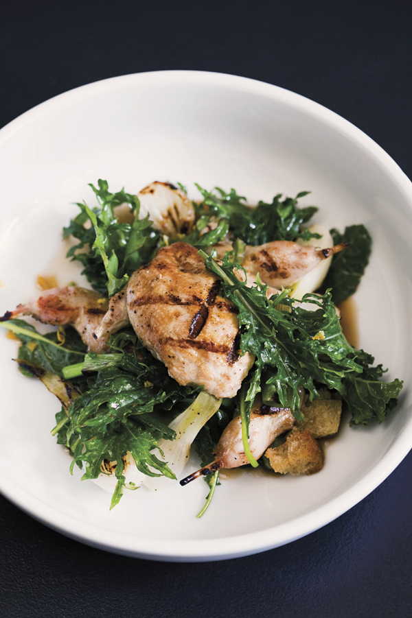 Grilled quail with wilted baby kale salad & charred spring onions