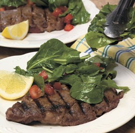 Grilled rib-eye steaks with arugula salad