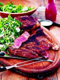 Grilled rib eyes with watercress, blue cheese and radish salad