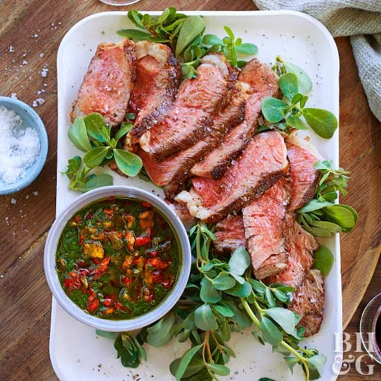 Grilled ribeye steaks with nasturtium pesto