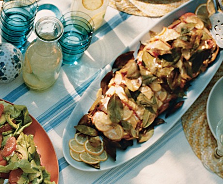 Grilled salmon wrapped in lemon and bay leaves