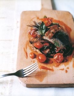Grilled sardines on toast with bacon, basil and tomato