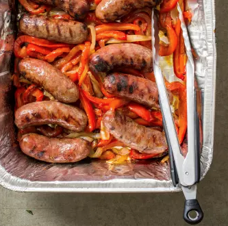 Grilled sausages with bell peppers and onions